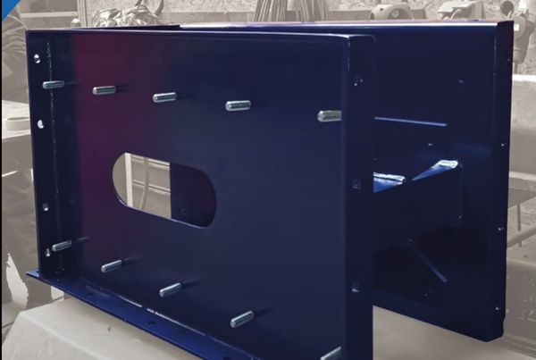 Caisson en tôle bleue avec goujons filetés et ouverture oblongue, réalisé en atelier de chaudronnerie